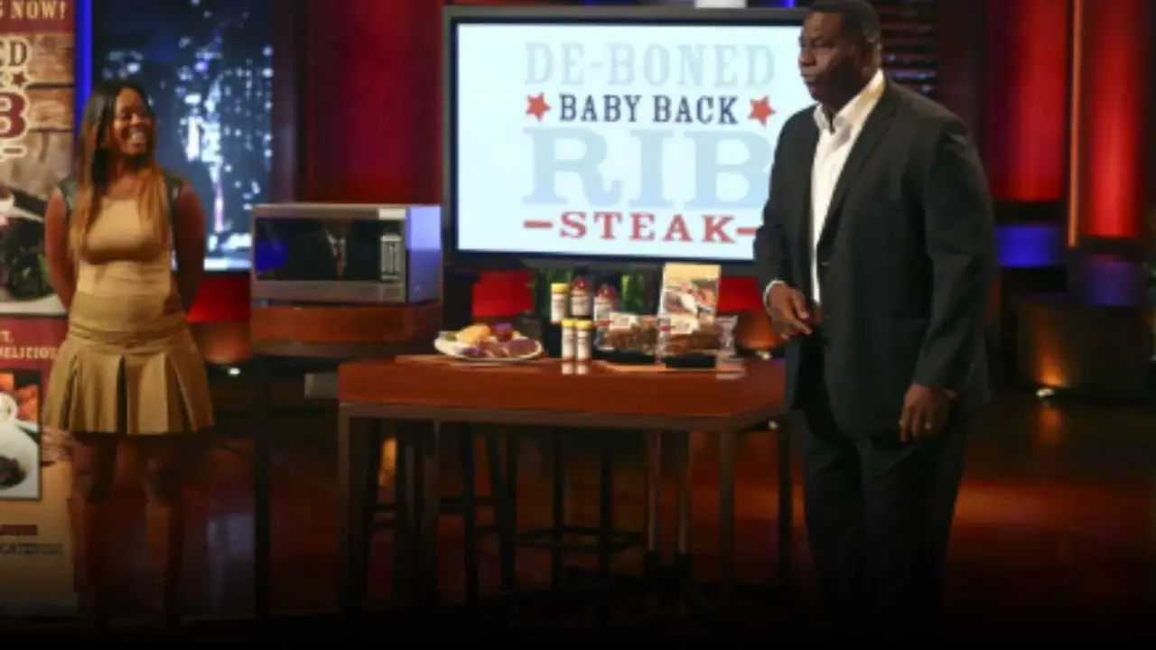 Al ‘Bubba’ Baker and Brittani Bo Baker pitching Bubba’s Q BBQ boneless ribs on Shark Tank, with a product display and branding behind them.