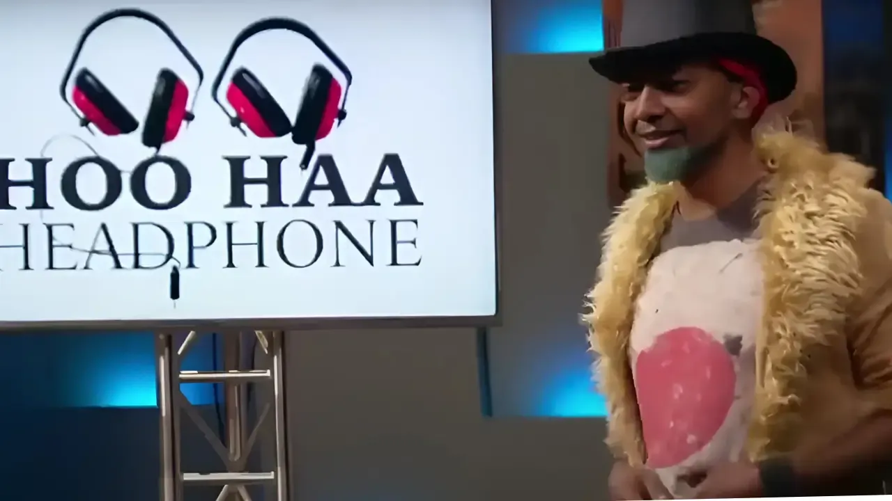 Entrepreneur pitching Hoo Haa Headphones on Shark Tank wearing a top hat and yellow fur coat