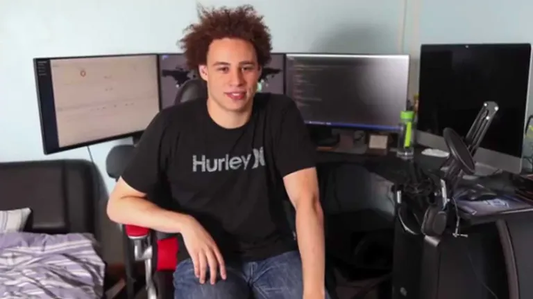 Marcus Hutchins sitting in front of multiple monitors in his home office where he discovered the WannaCry kill switch