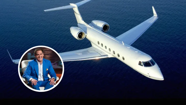 Mark Cuban smiling in a blue suit with his Gulfstream V jet flying over the ocean, representing his record-breaking $40M online purchase in 1999.