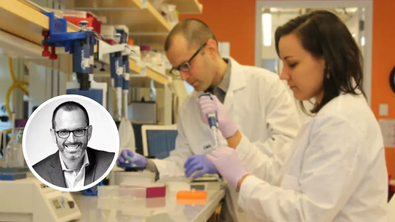 Yaniv Erlich and his research partner working in a lab on DNA data storage technology, wearing lab coats and using pipettes